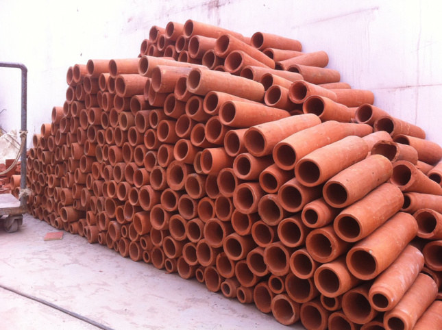 Photo of a stack of terra-cotta tubes