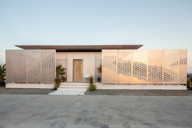 A view of a single level home in the Desert with a screened courtyard