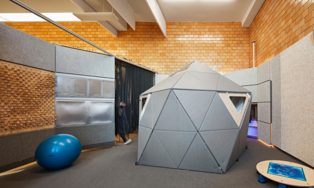 A gray geodesic pod in an interior.