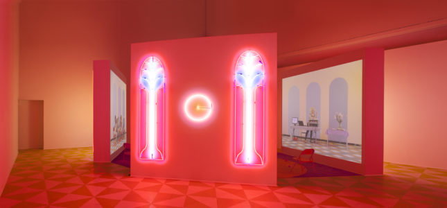 Alex Da Corte (b. 1980) with Jayson Musson (b. 1977), Easternsports, 2014. Four-channel video, color, sound; 152 min., with four screens, neon, carpet, vinyl composition tile, metal folding chairs, artificial oranges, orange scent, and diffusers. Score by Devonté Hynes. Collection of the artists; courtesy David Risley Gallery, Copenhagen, and Salon 94, New York. Installation view, Institute of Contemporary Art, University of Pennsylvania, 2014 © Alex Da Corte; image courtesy the artist and Institute of Contemporary Art, University of Pennsylvania
