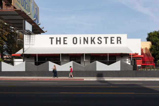 Cofounders Catherine Johnson and Rebecca Rudolf evoke Vans sneakers and L.A.’s burger stand culture in The Oinkester restaurant, for which they cleaned up an old, neglected commercial building and added a wraparound patio and picnic blanket-patterned VCT tiles. (Courtesy Laure Joliet)