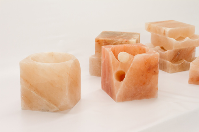 A Toolkit for a Newer Age is composed of nine objects carved of pink Himalayan salt that correspond to human activities such as eating, sleeping, and meditating. (Courtesy Leong Leong)