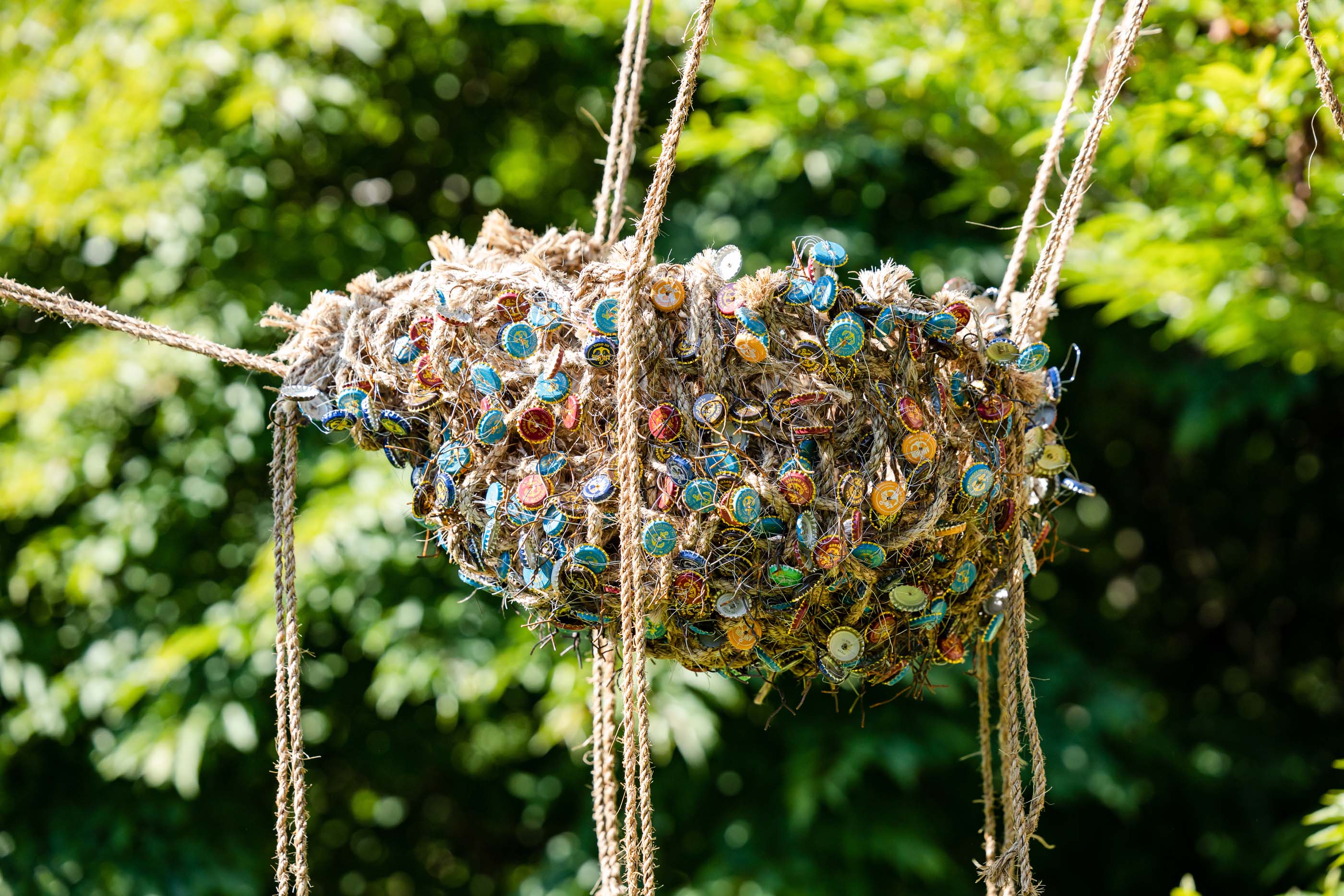 bird nest made from rope and bottle caps