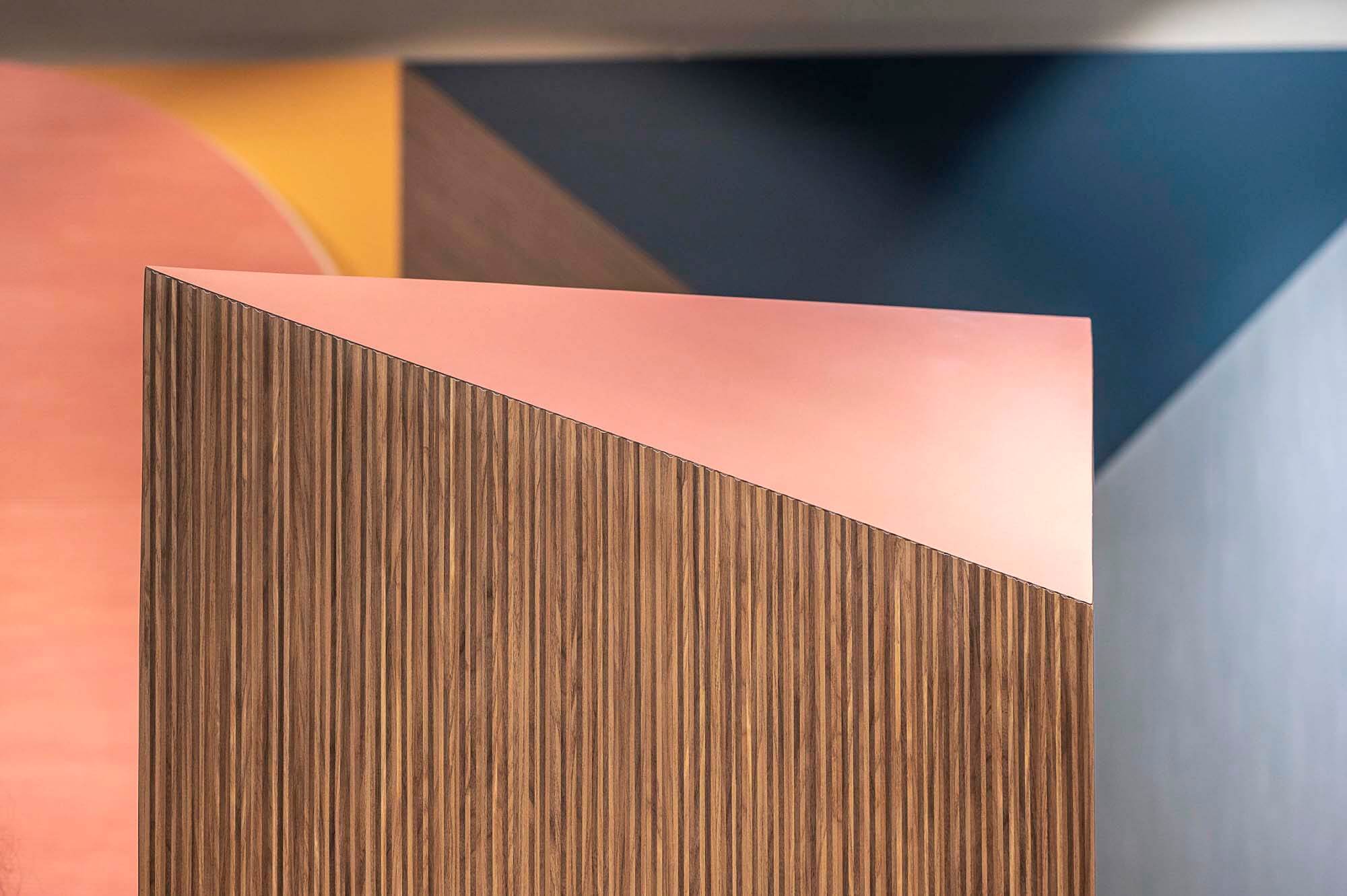 textured Tuet tile in vertical brown lineal pattern against contrasting pale pink triangle