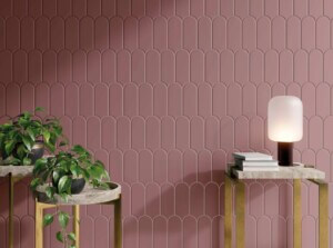 Wall of narrow pink scallop tiles behind two modern brass and stone side tables