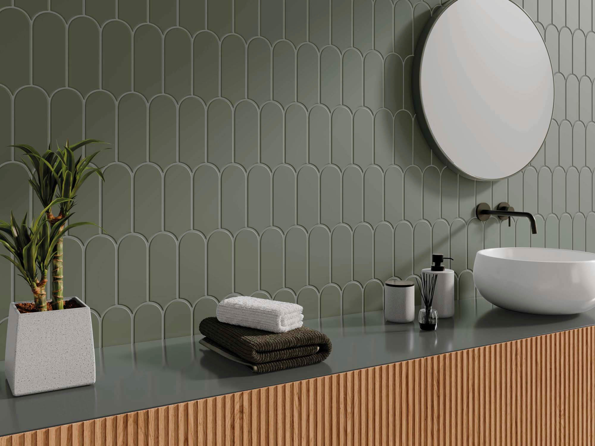 Wall of narrow green scallop tiles at a bathroom sink