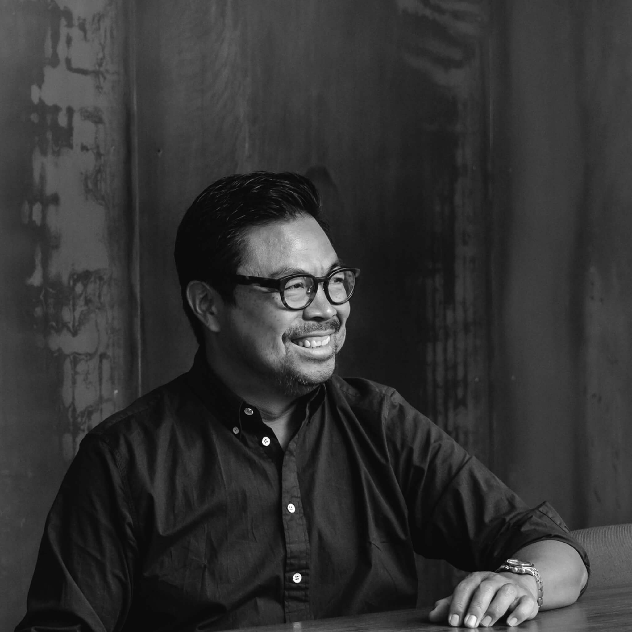 A black and white photo of a man sitting