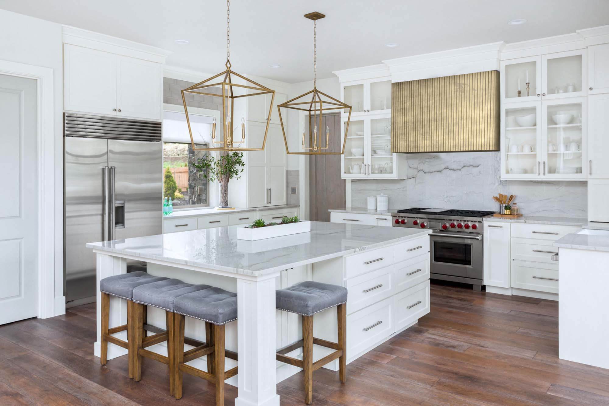 Modern kitchen with golden textured metal range hood by La Bastille