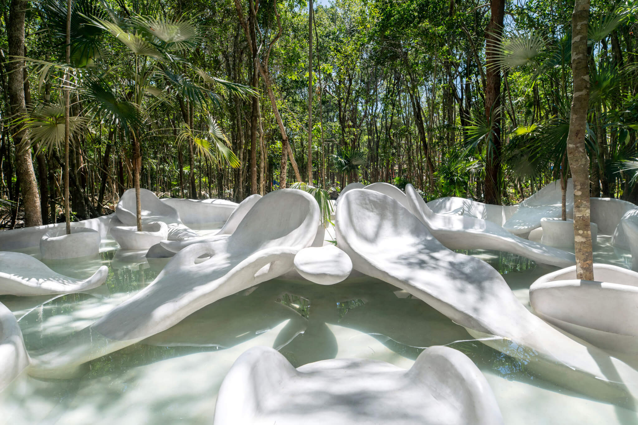 organic-shaped sculptures in water feature are part of the En-chanted Garden