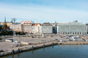 seafront view of a vacant lot with scandinavian houses in the backrgound