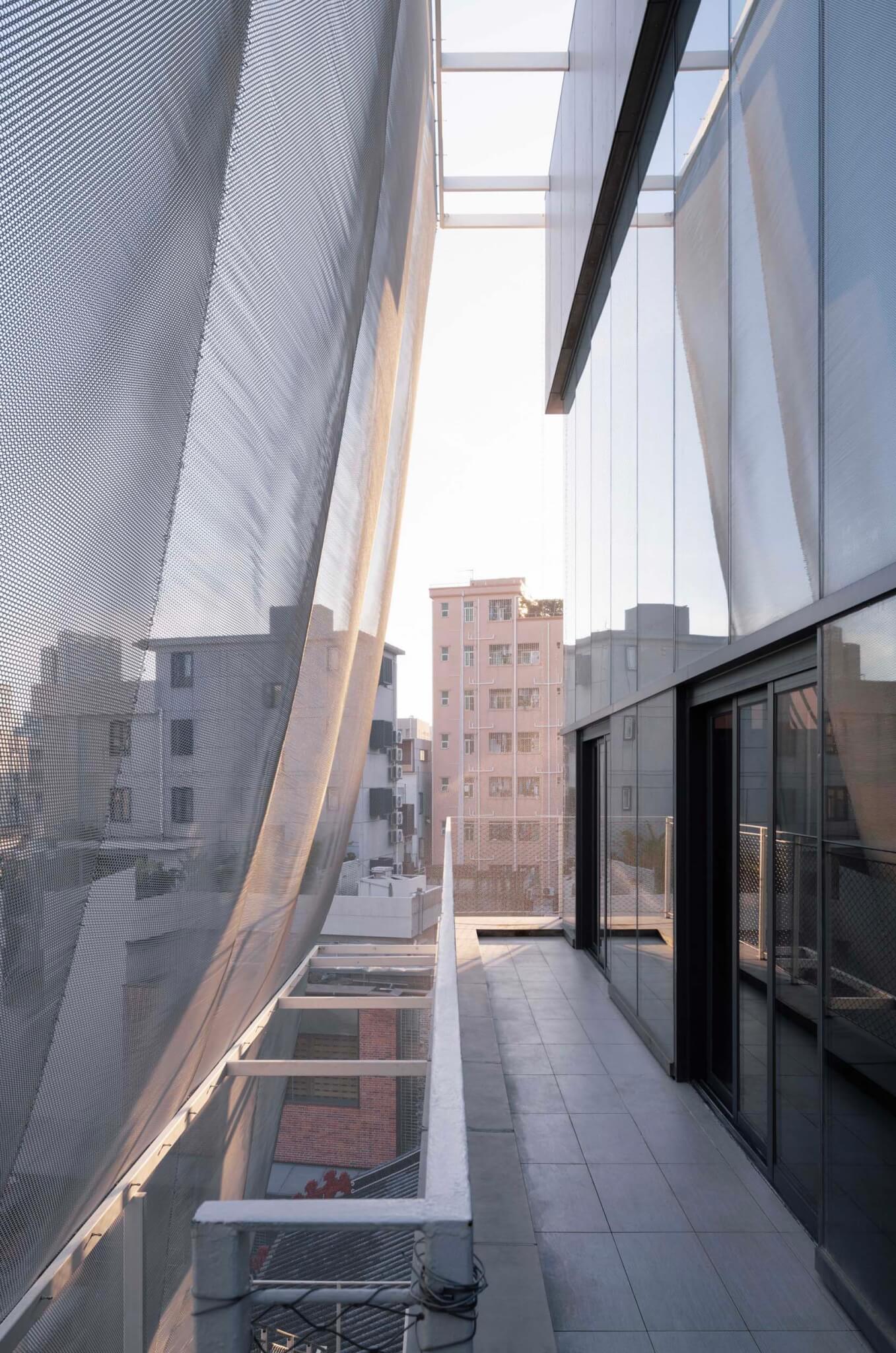 walkway on building facade between curtain and facade