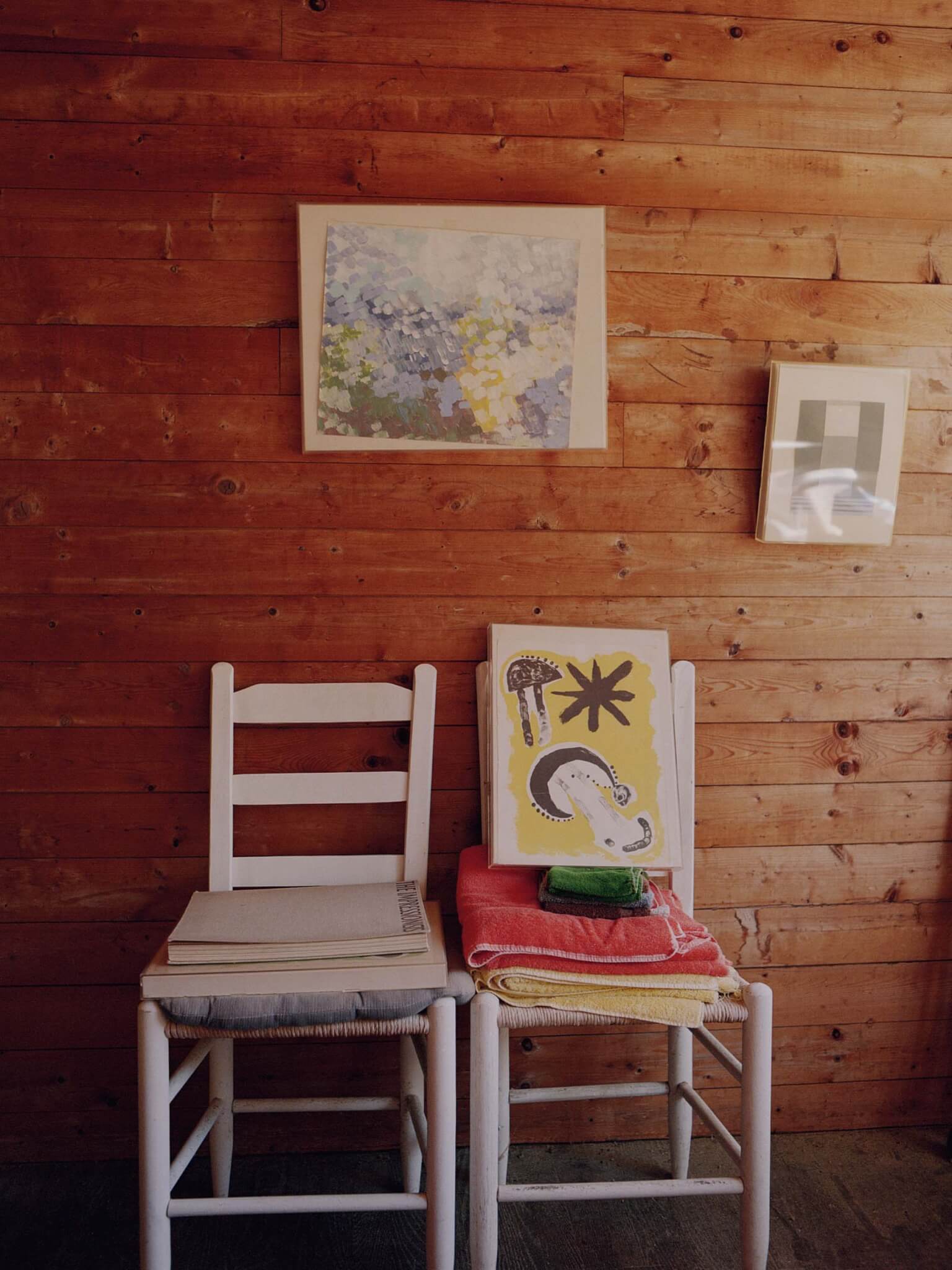 two chairs against wood wall