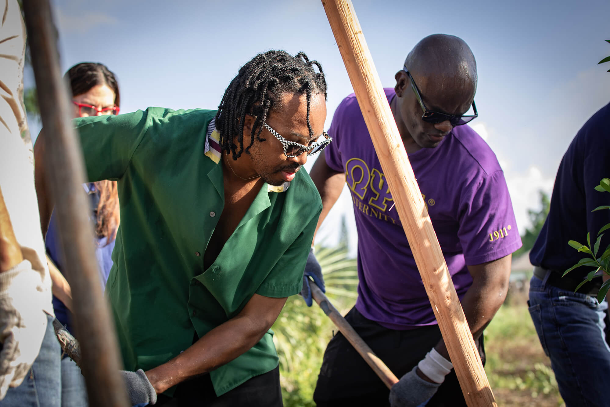 Ekene Ijeoma, Poetic Justice’s founder, plants a tree alongside volunteers in St. Louis.