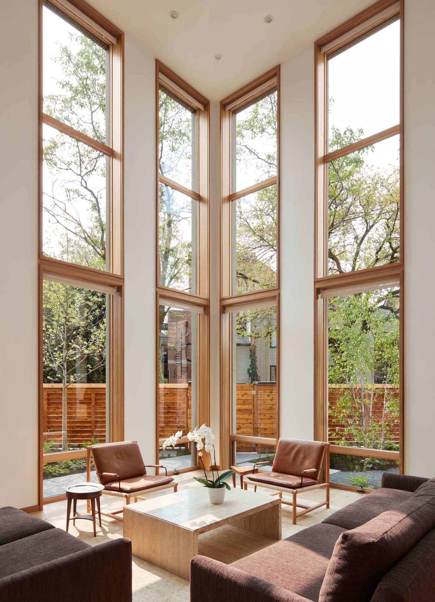 wood-framed windows in room tall ceilings