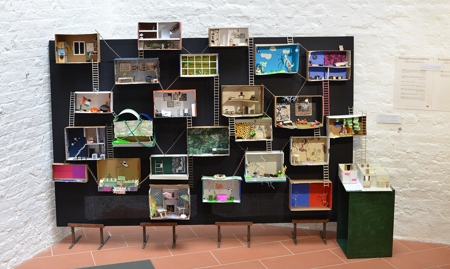 doll houses mounted on display wall