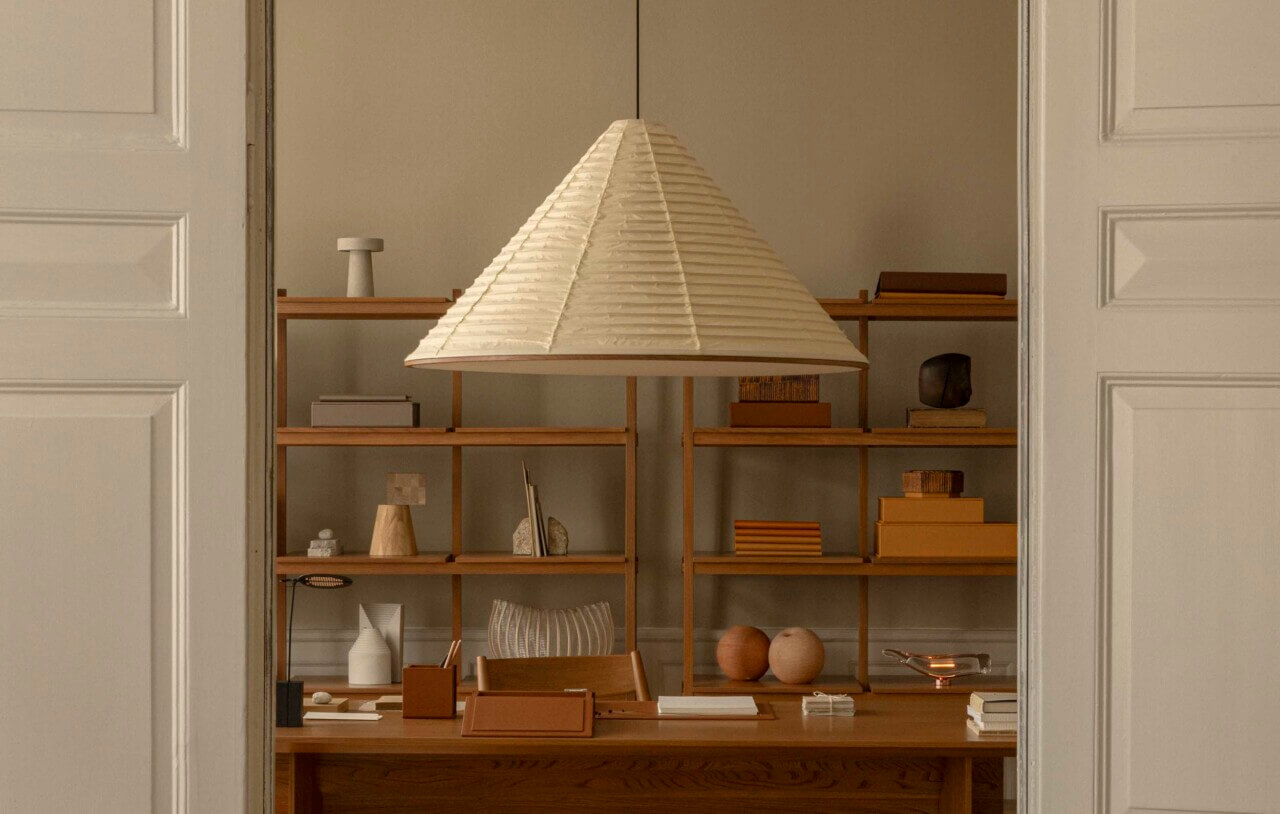 beige lamp hanging in front of wooden case