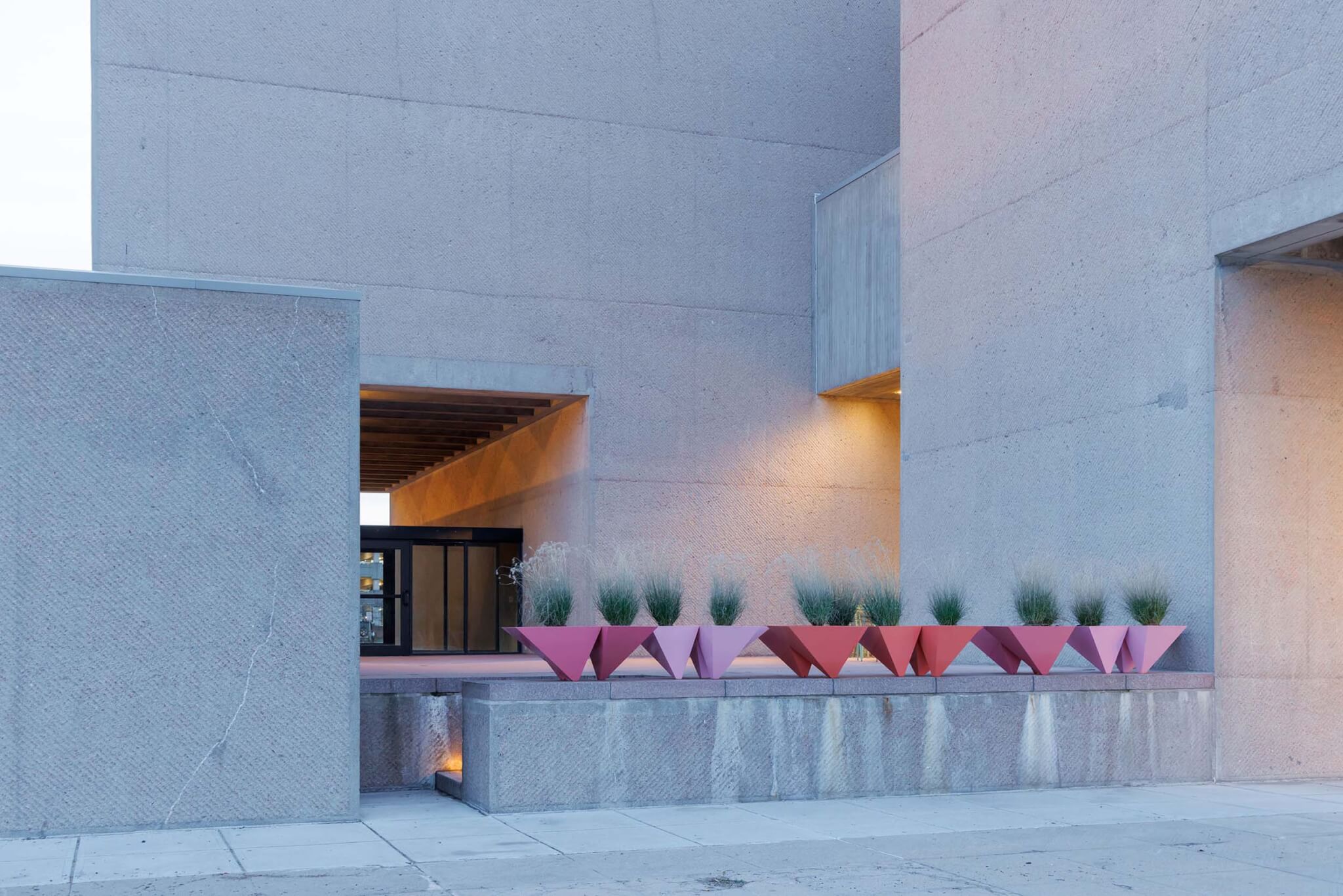 pink, pyrmidial planters outside the Everson Museum of Art