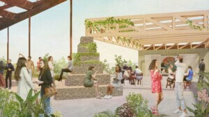 People walk beneath a cantilevered wooden roof at Monospace, a multi use food and music venue in Chattanooga, Tennessee and designed by Mattaforma.