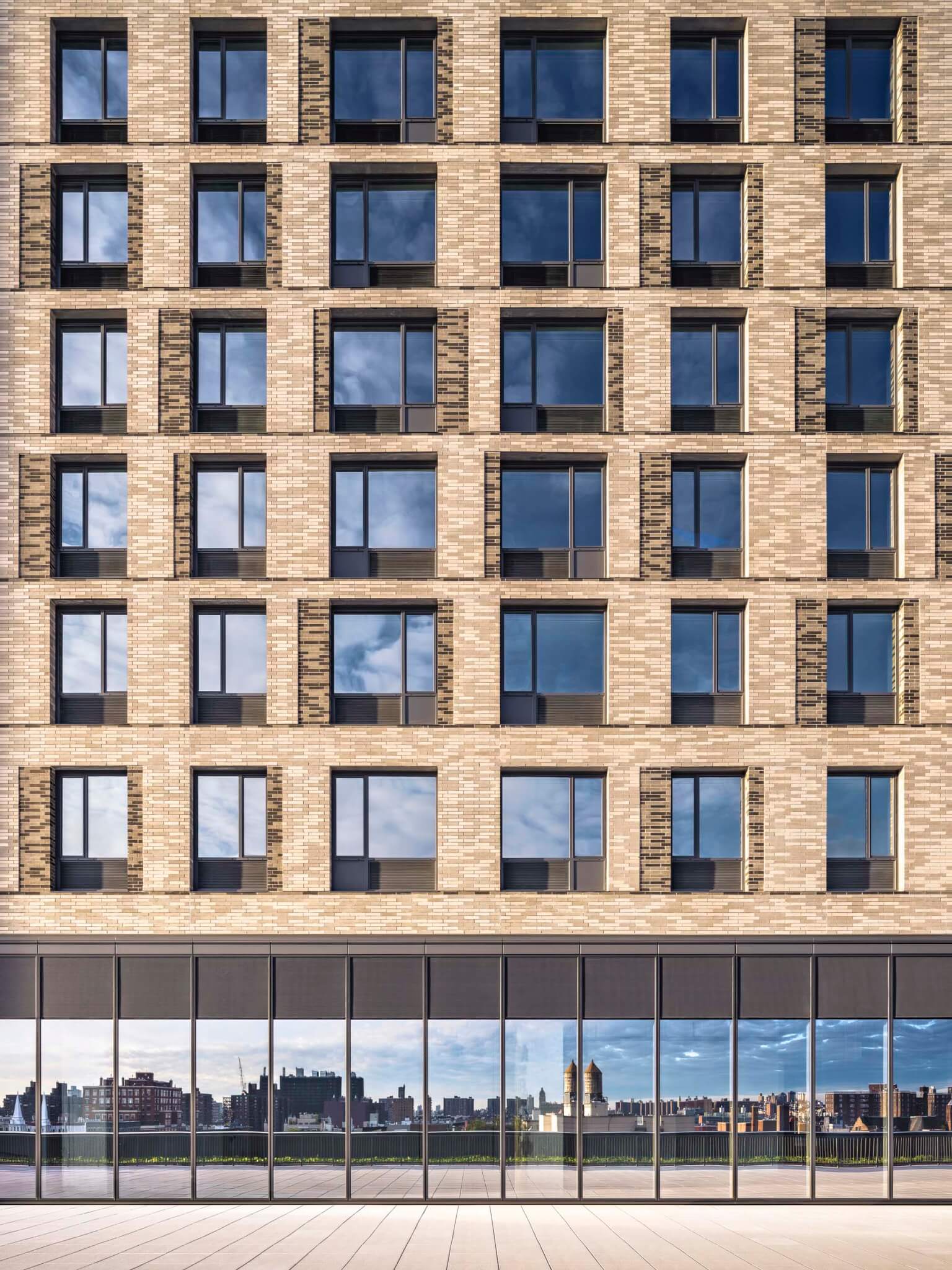 masonry facade with reflective glass