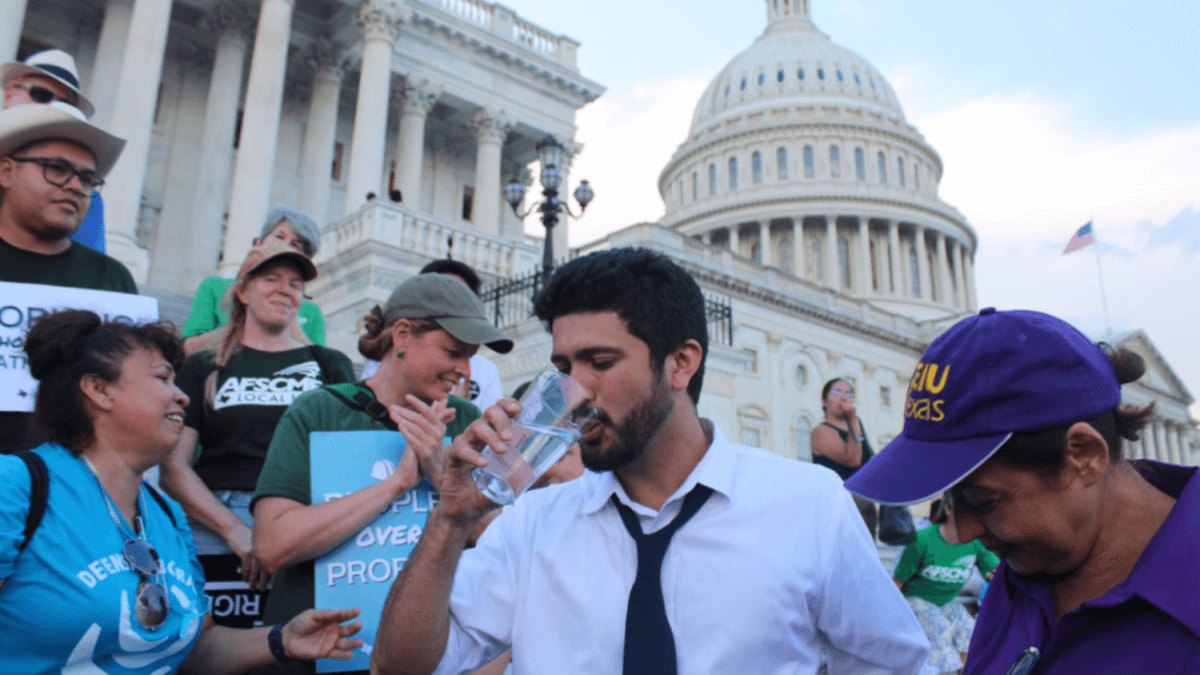 Congressman Casar drinking water cup