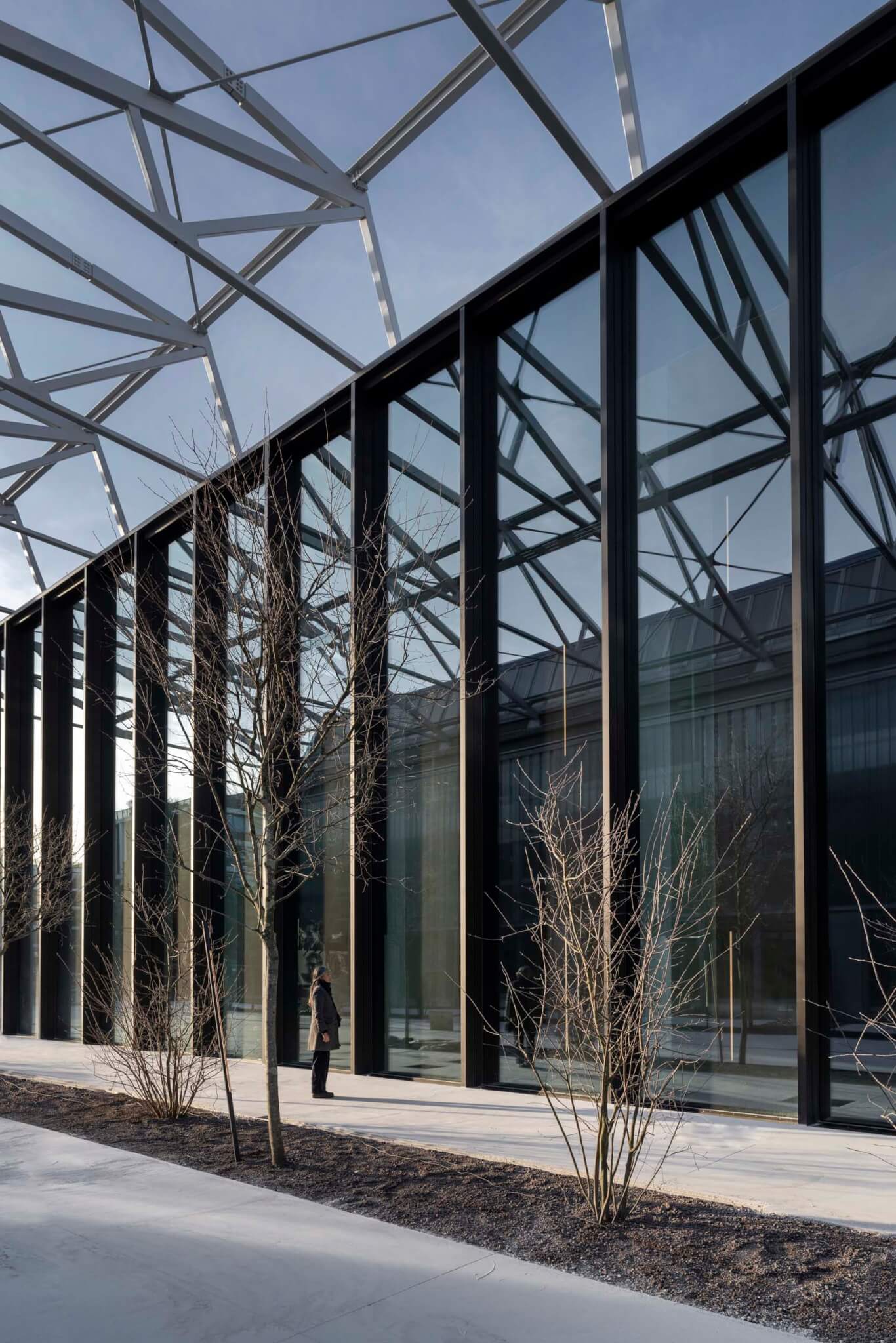 the old factory building has a sawtooth roof in laid with glass panels