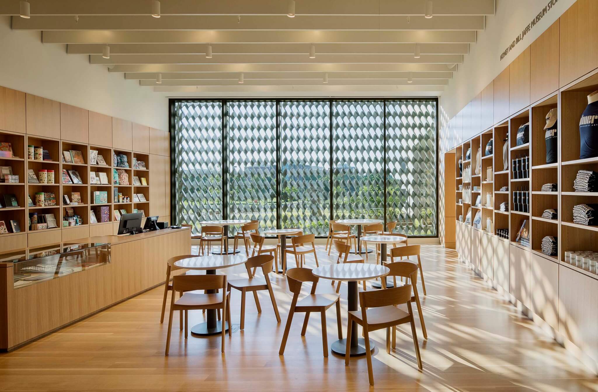 a library room with shelves and desks and chairs