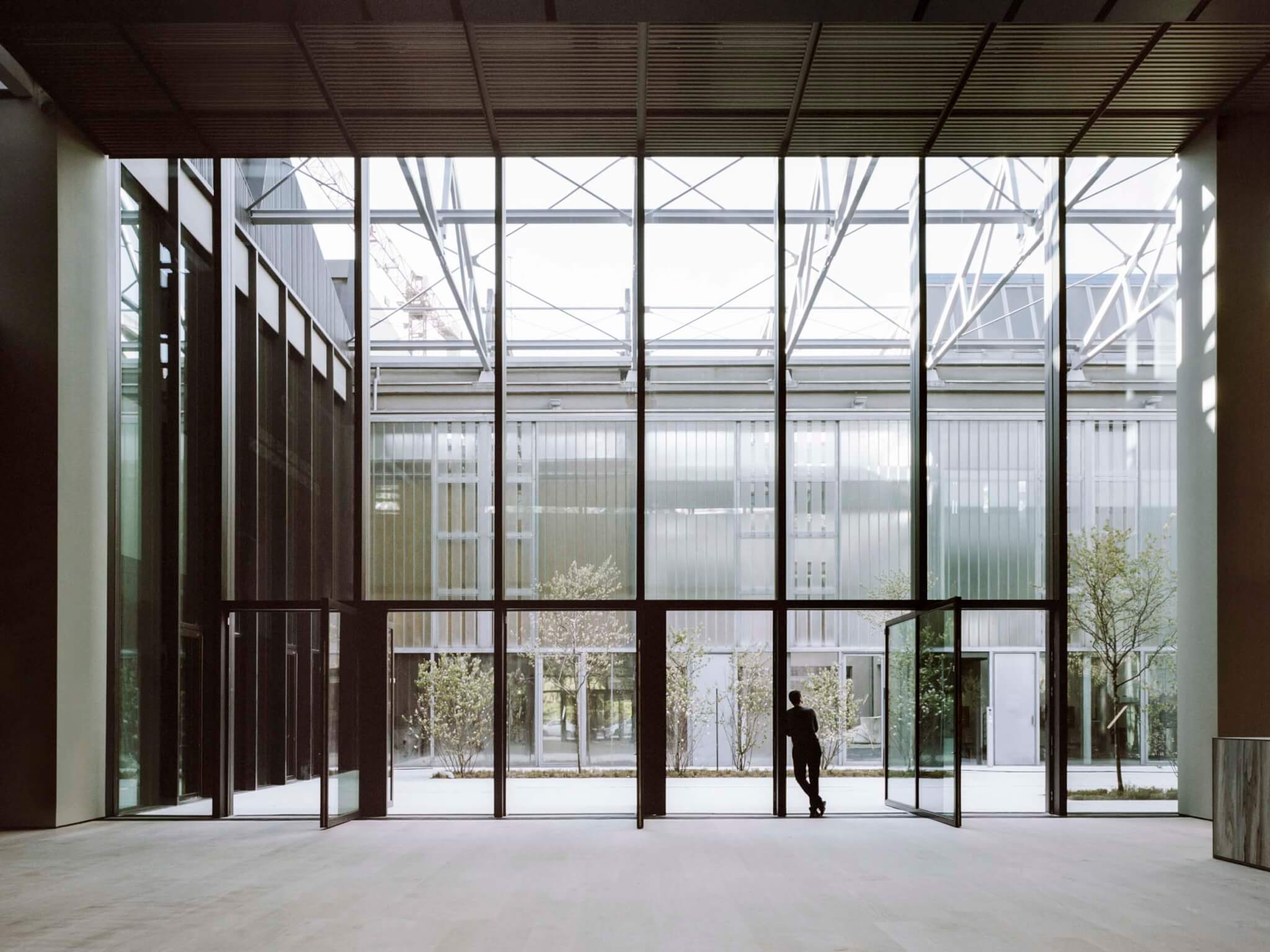 the glazing extends from floor to ceiling in the office building for Luxottica headquarters