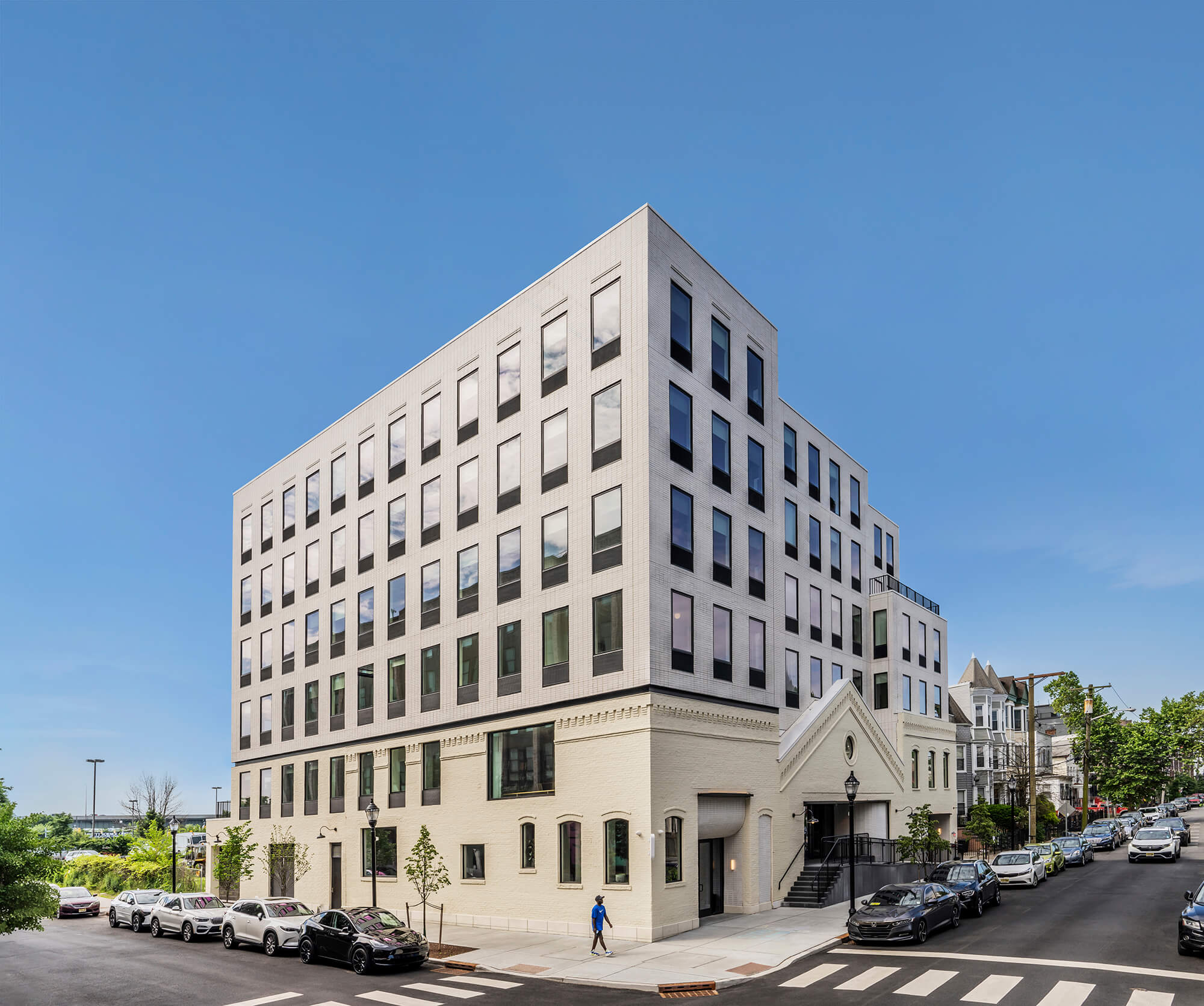 the top of Starling by GRT Architects features stacked-bond bricks that are white