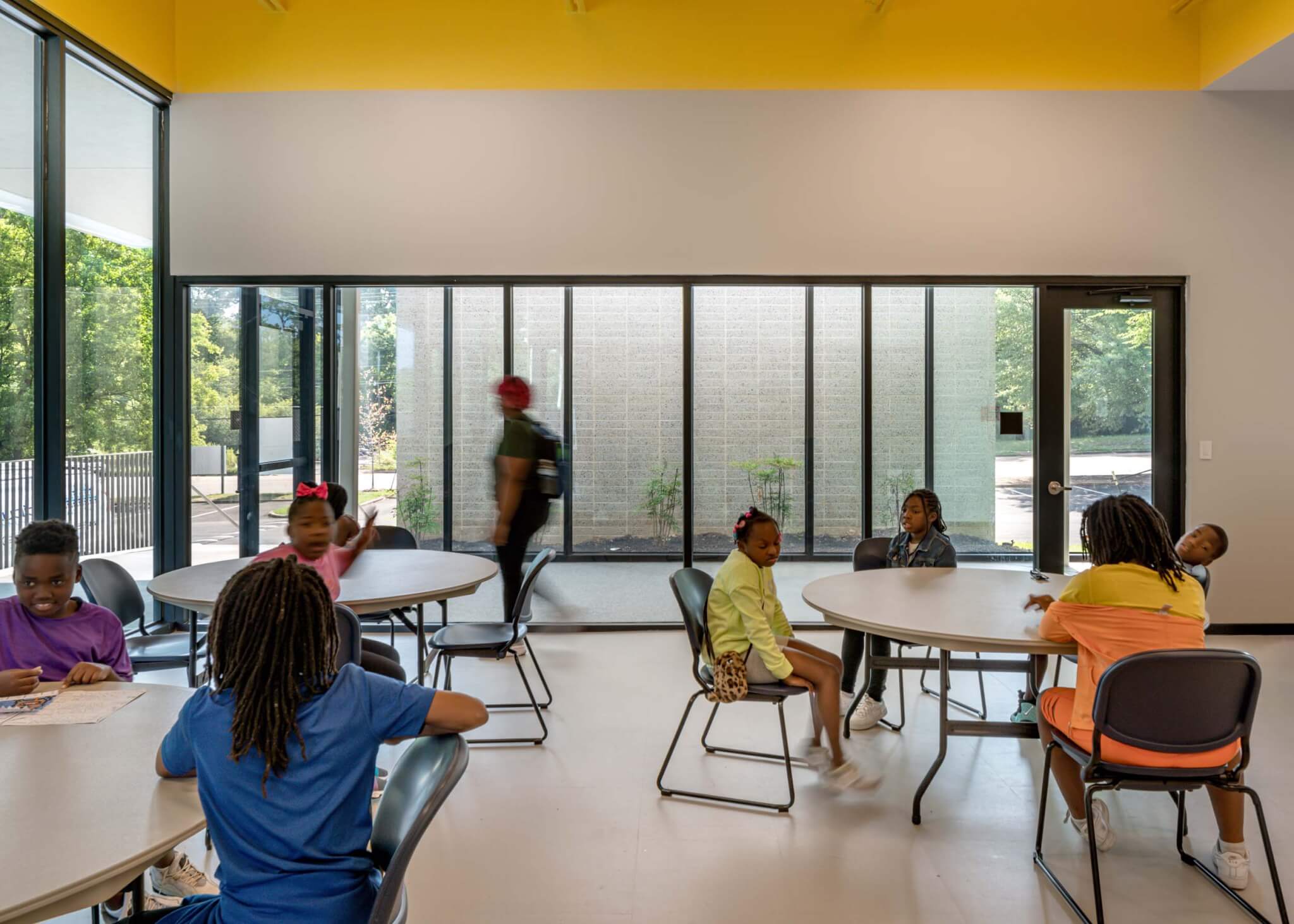 interior room with kids sitting at round tables