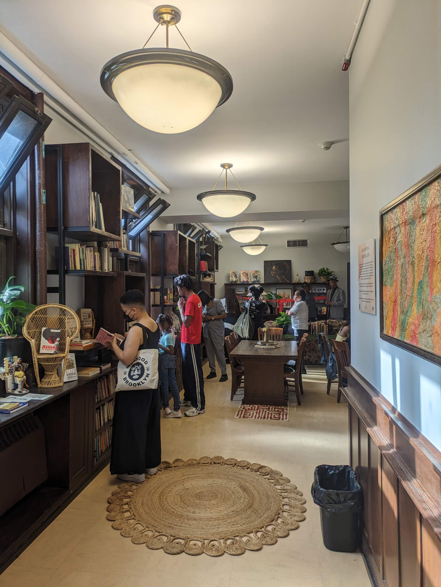 people browsing books inside the reading room at the Brownsville Heritage House recently renovated by BlackSpace