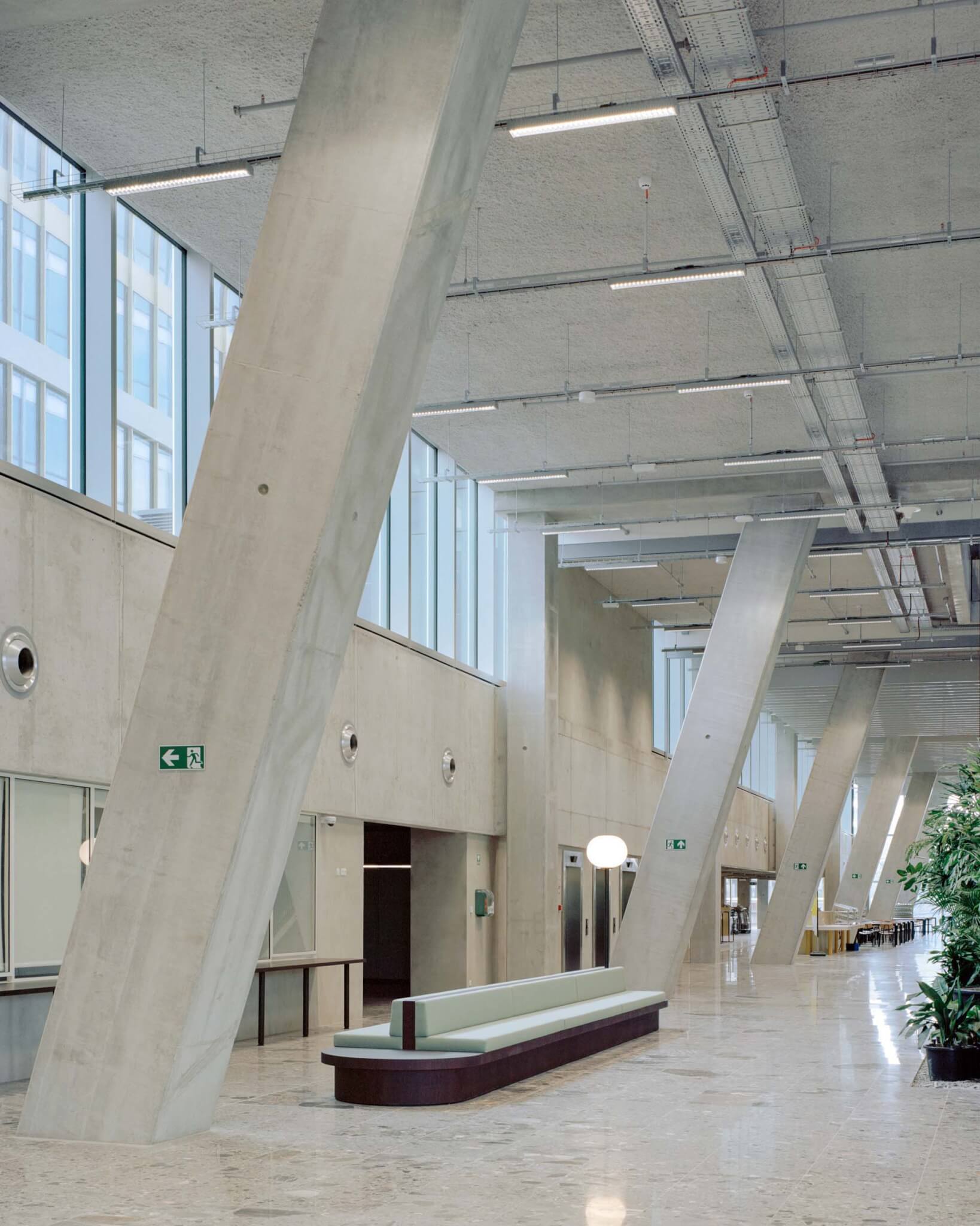 large spans of concrete walls inside World Trade Center by 51N4E in Belgium