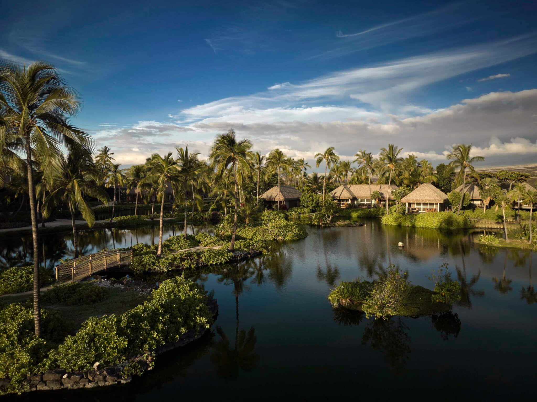 Kona Village huts designed by Walker Warner located around a body of water