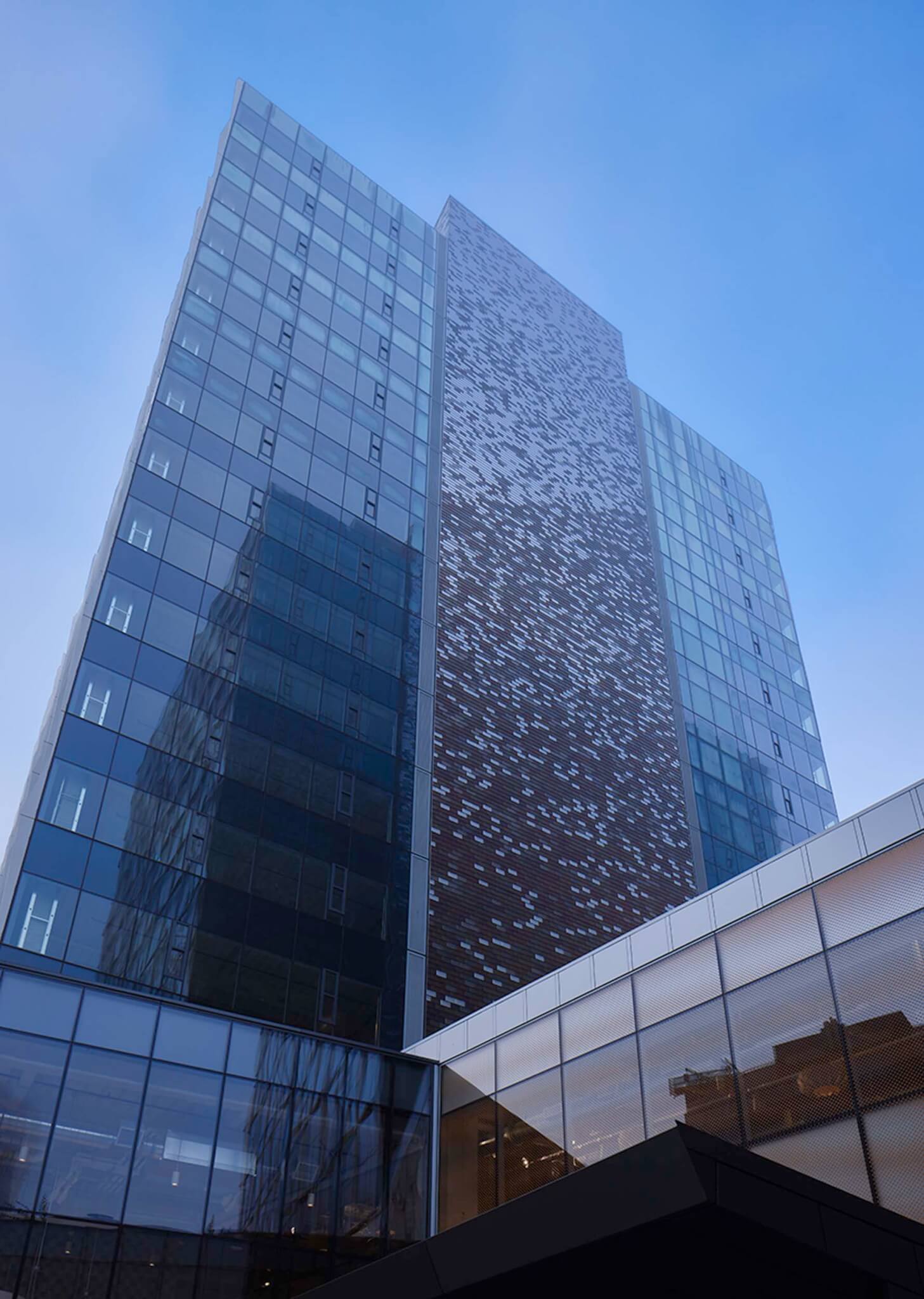 the exterior of the elevator core is clad in mosaic tiles