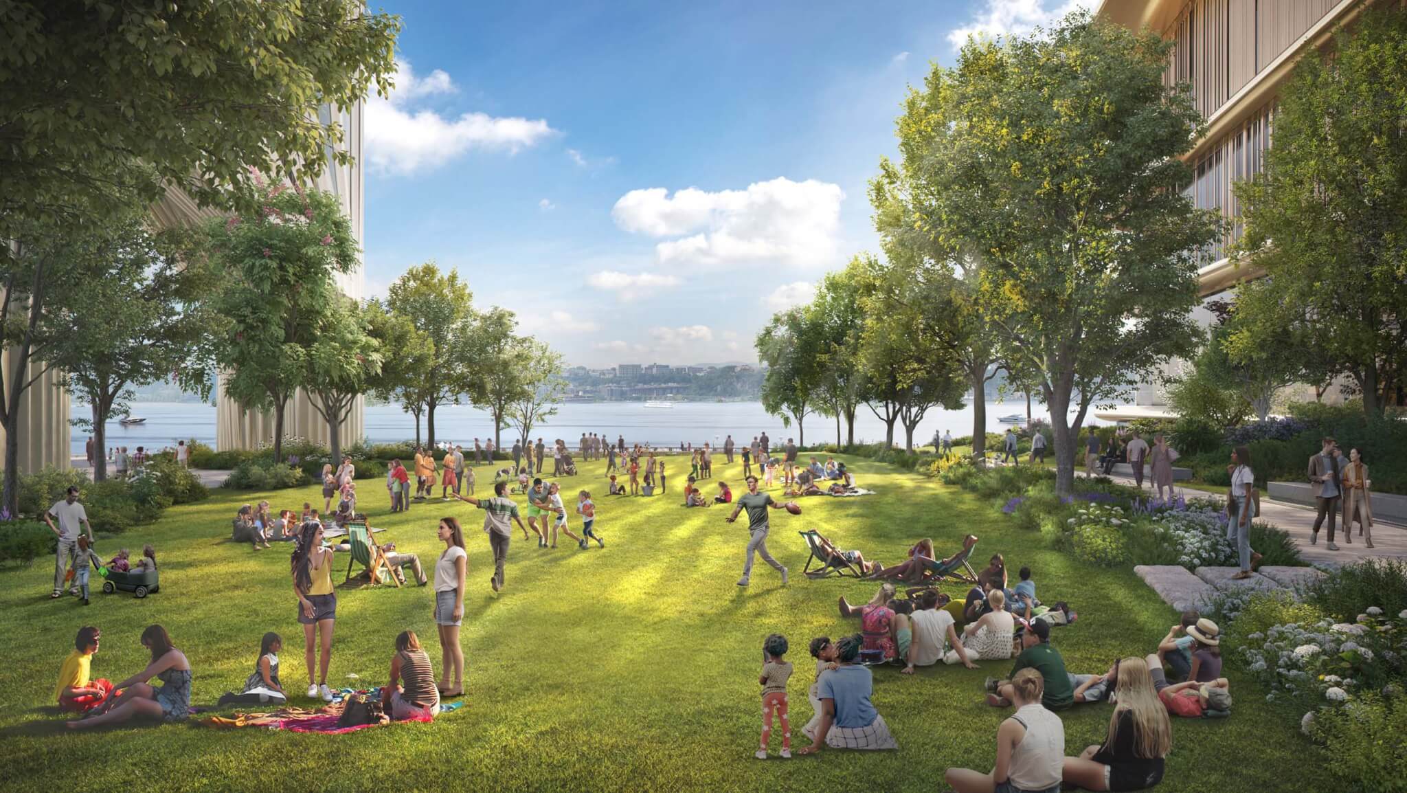 people sitting on grassy lawn looking out toward river