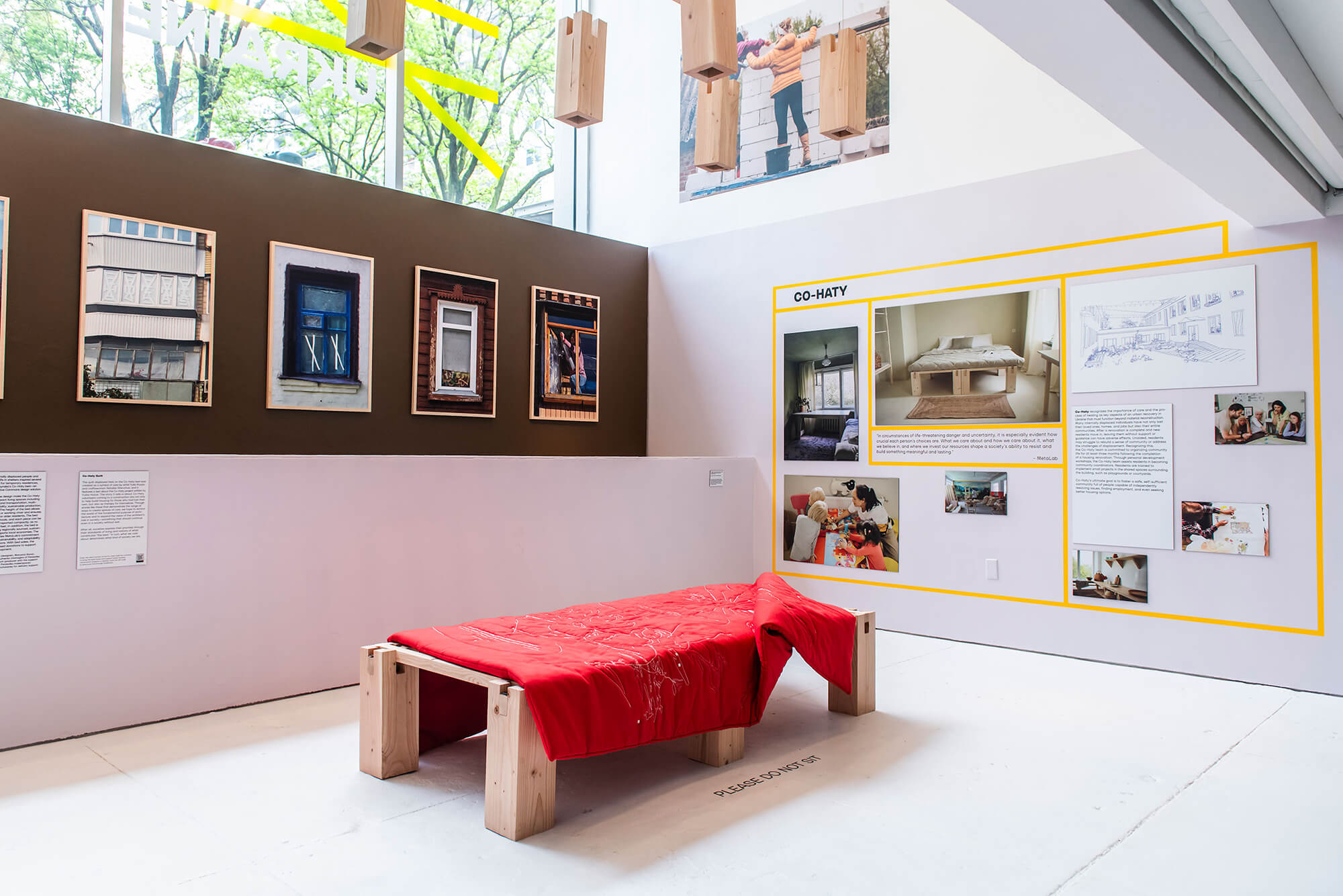 a wood bed on display with exhibition text at Center for Architecture