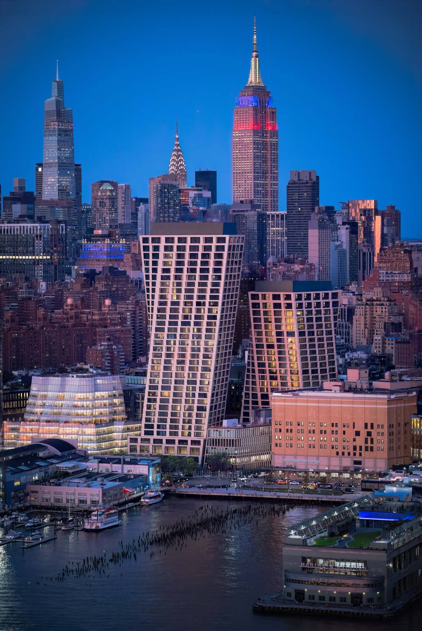 Night view of the towers with nearby skyscrapers and Chelsea Piers