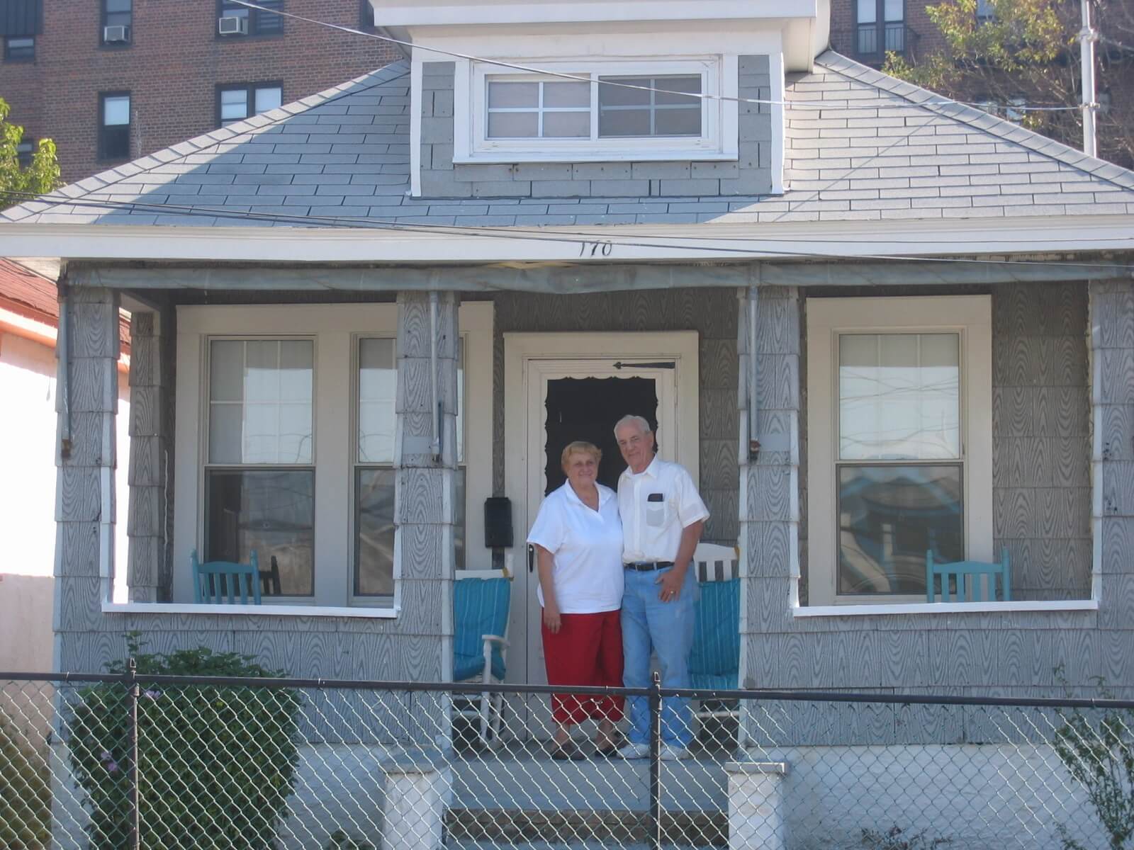 house in the rockaways with residents standing outside front door