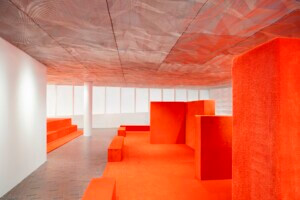 An orange stage and set pieces at Walker Art Center