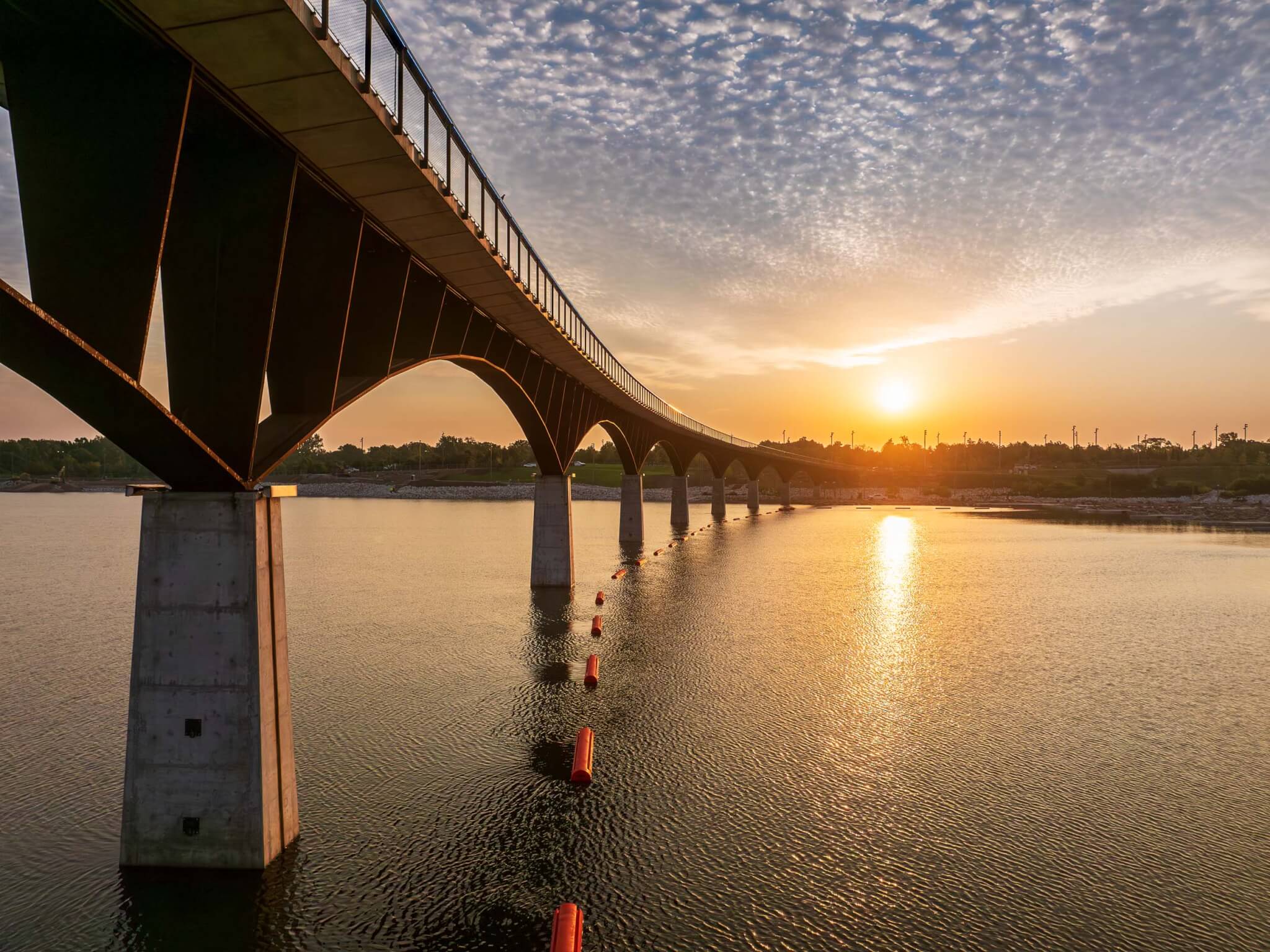 sunset over bridge and water in Tulsa