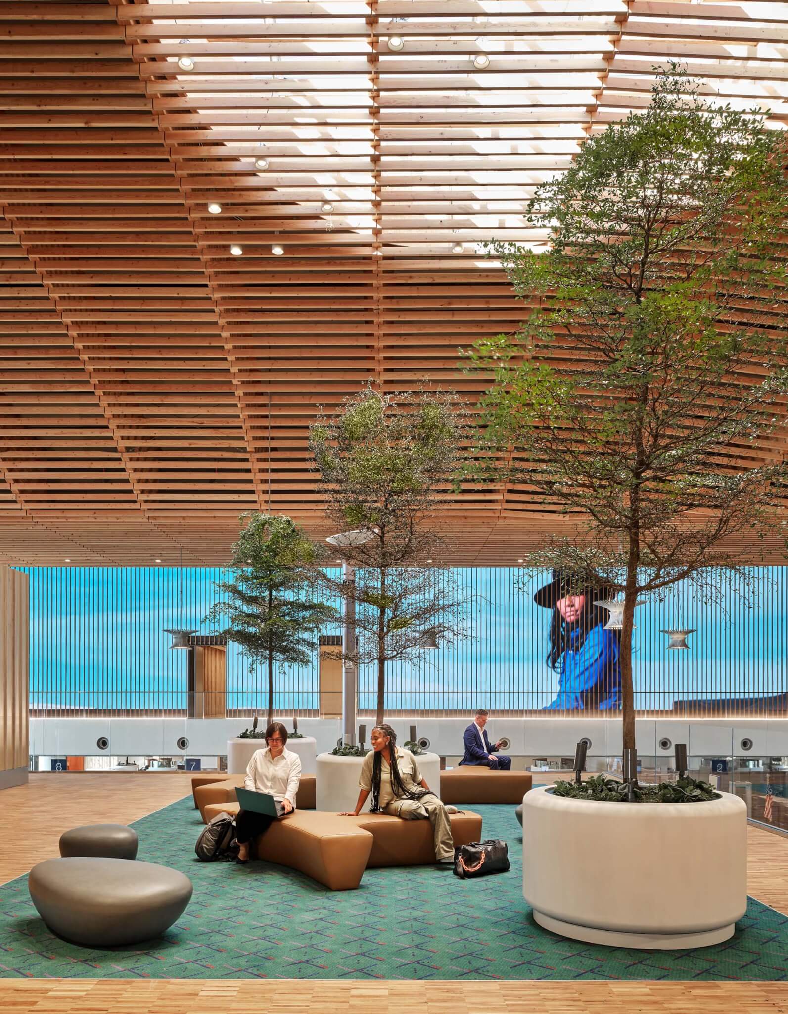 a carpeted lounge space in the airport terminal