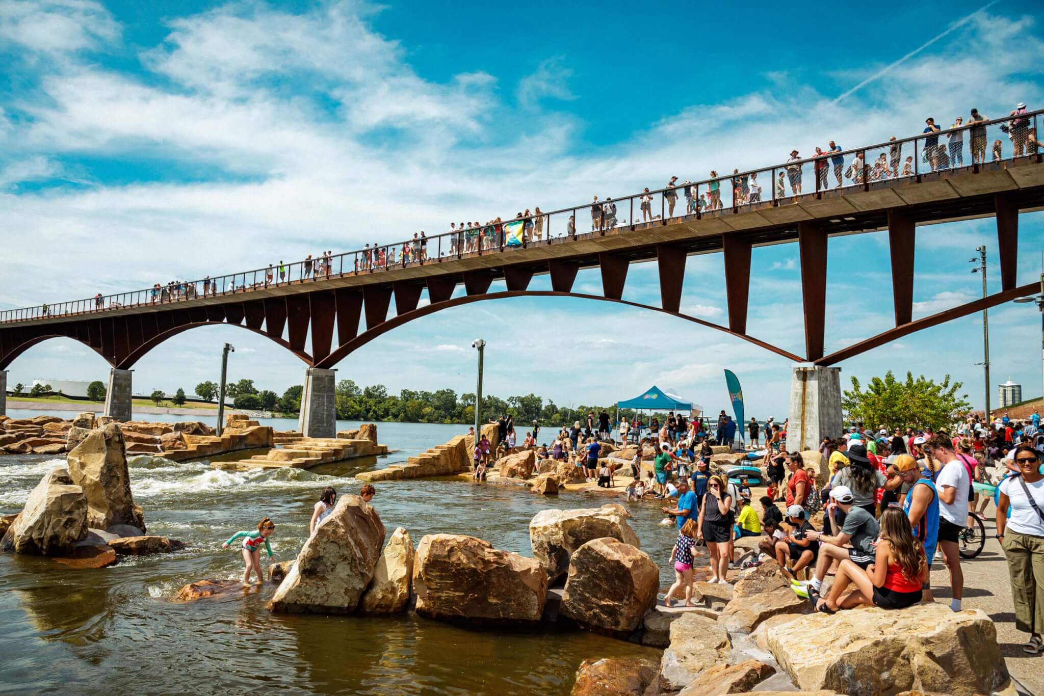 people by pier and on bridge over water