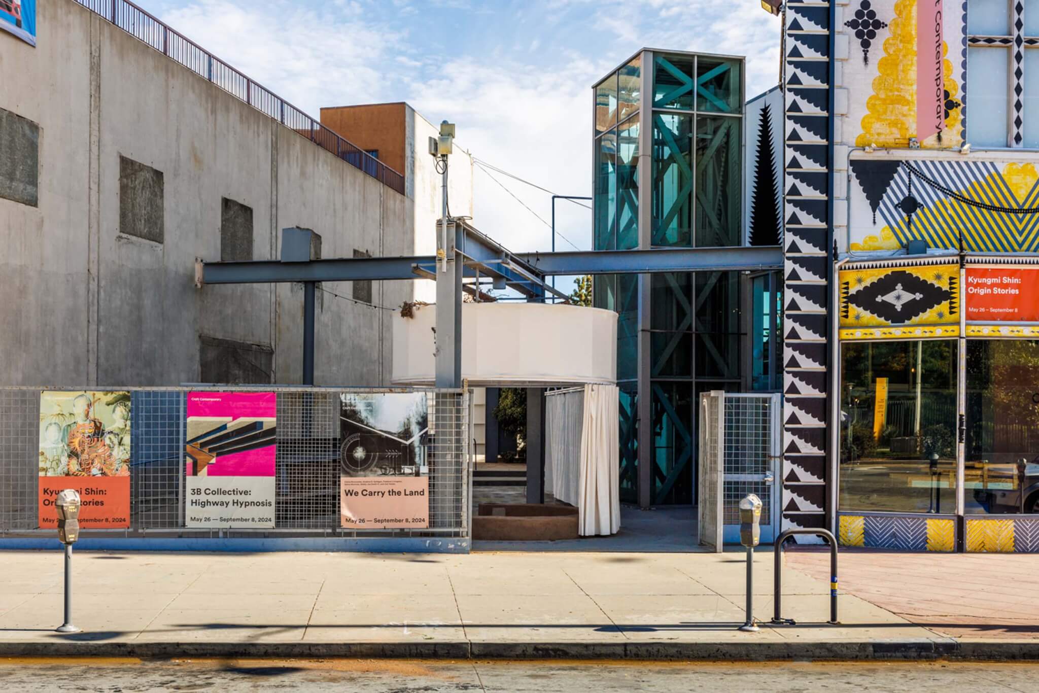 view of We Carry the Land installation from the street in its urban context