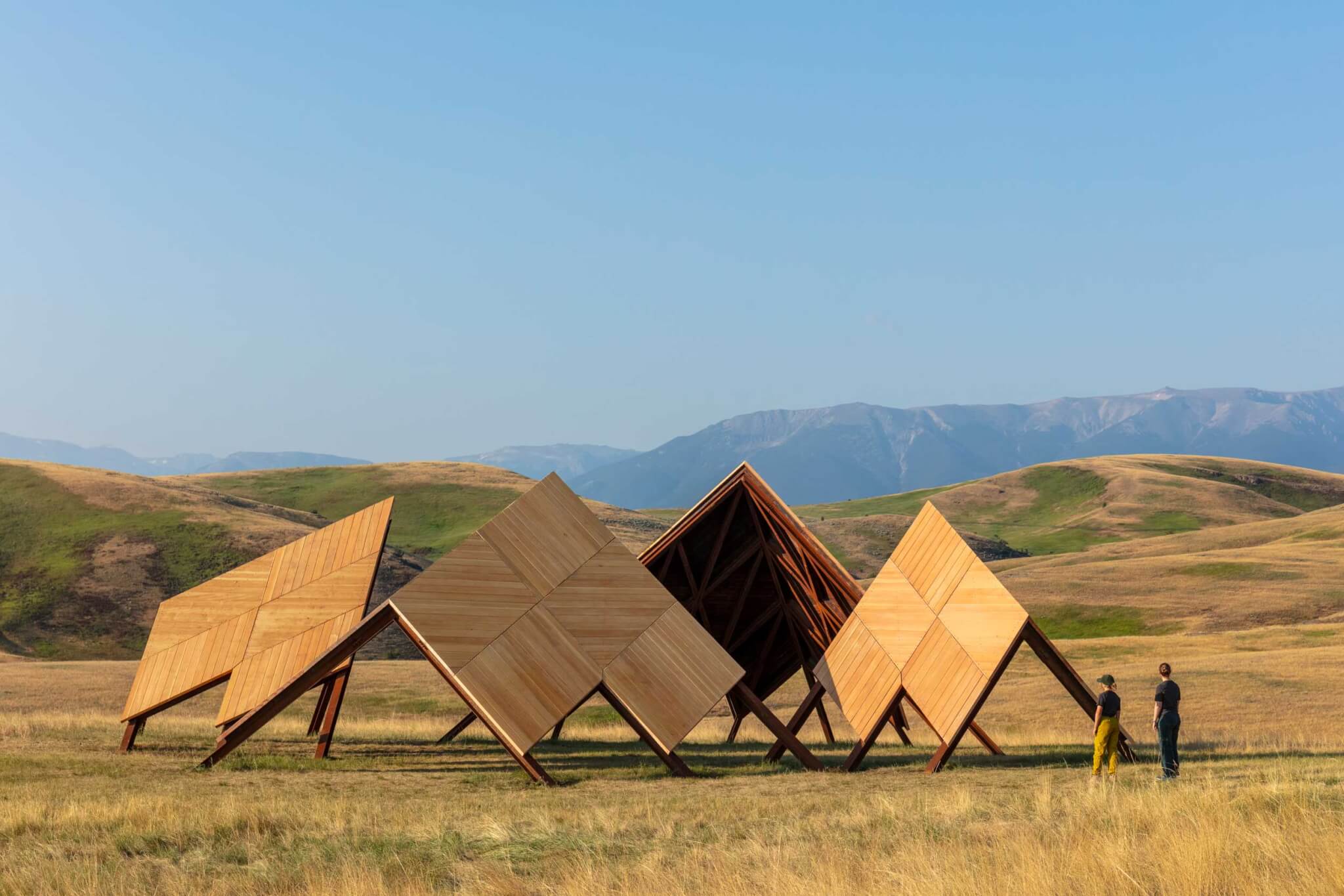 view of pavilion in a grassy field with mountains in background