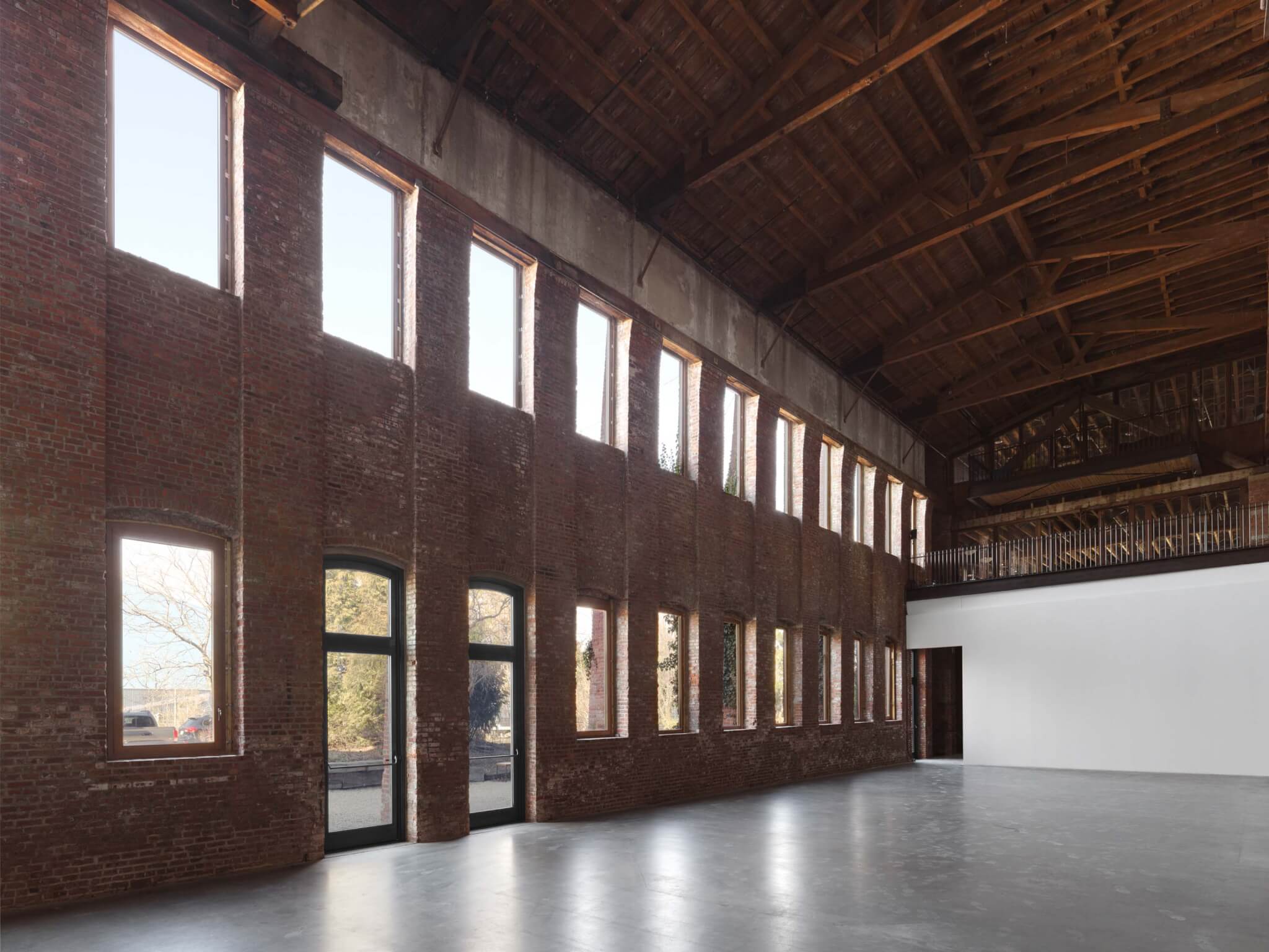 punched windows line the facade of pioneer works in red hook, brooklyn 