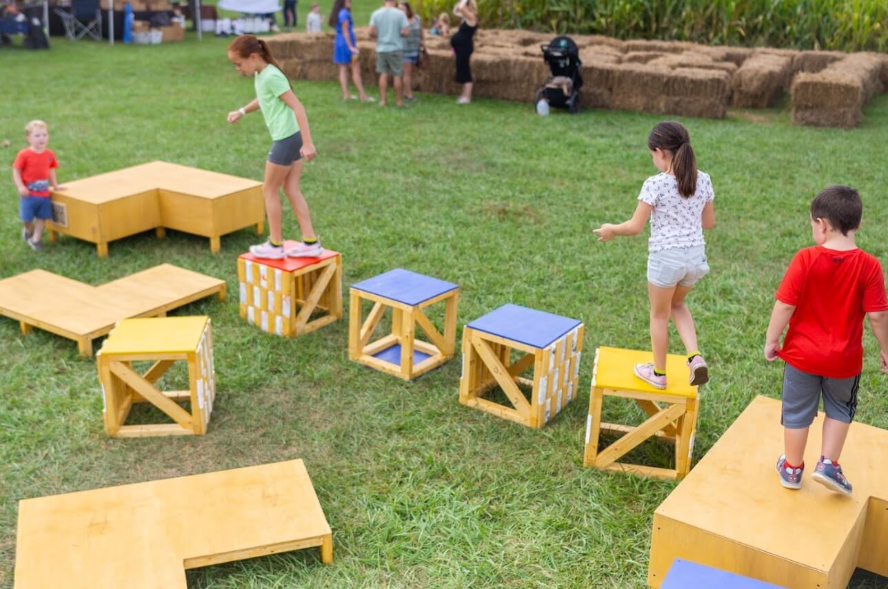 kids stepping on cube boxes