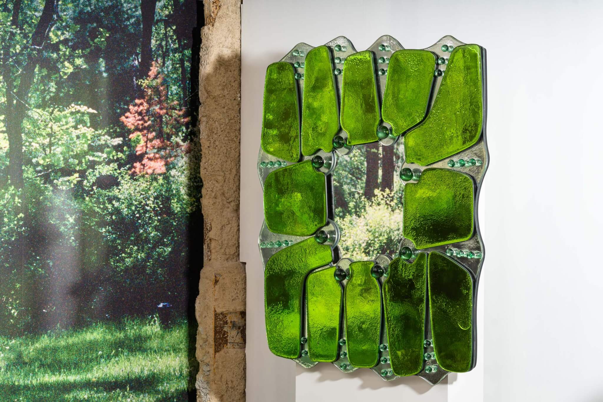 A green mirror hands next to a green painting at Collectible