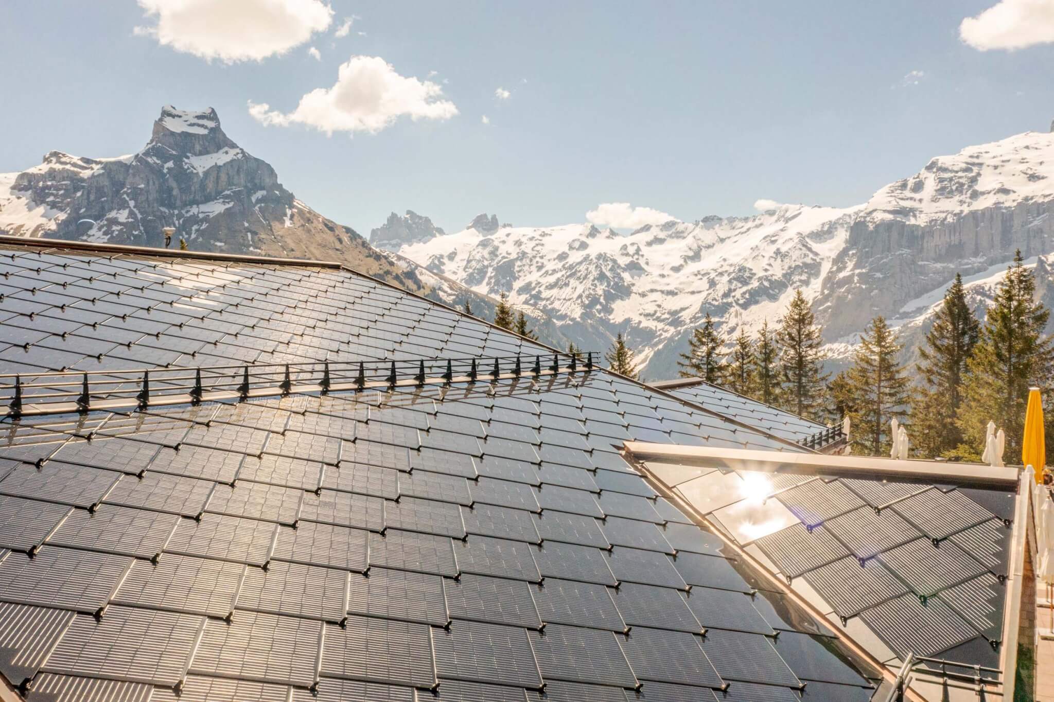 Solar panels on a roof on a house in front of mountains