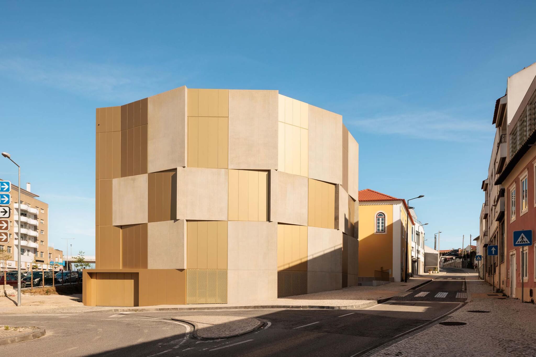 exterior image of apartment with beige and yellow gold overlapping precast concrete panels