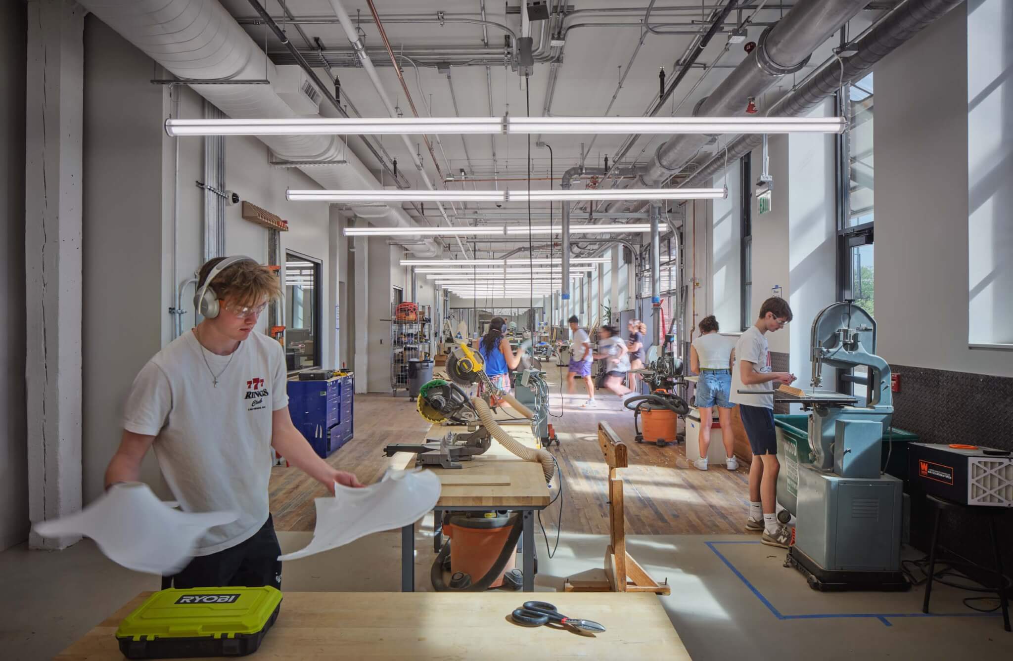 students work in an open-plan study space inside an old warehouse building