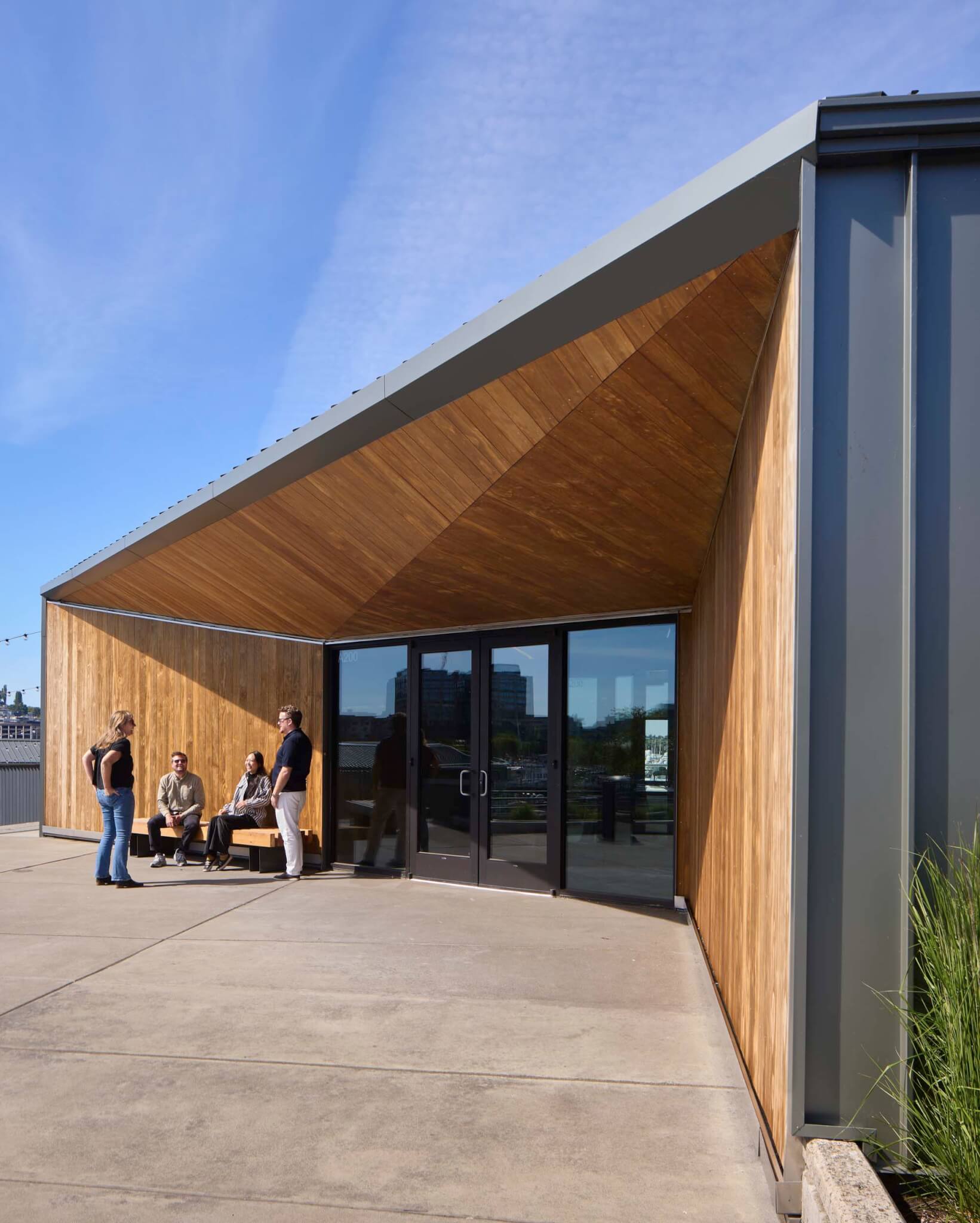 people sitting under eave of Lake Union Piers by Miller Hull